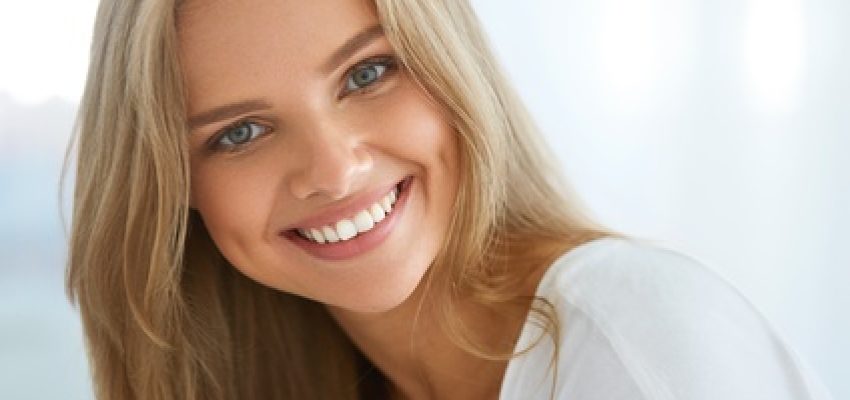 Beautiful Woman Smiling. Portrait Of Attractive Happy Healthy Girl With Perfect Smile, White Teeth, Blonde Hair And Fresh Face Smiling Indoors. Beauty And Health Concept. High Resolution Image